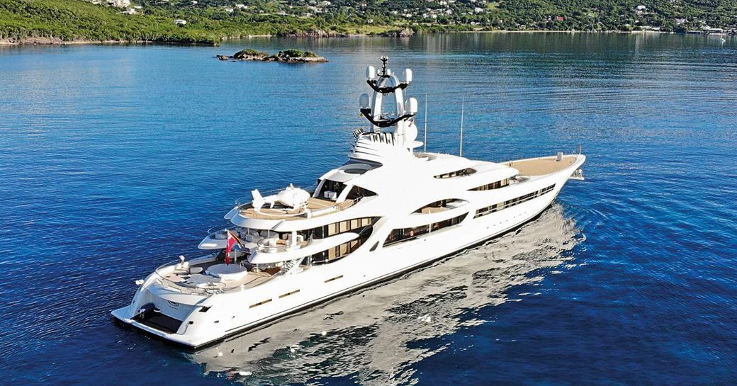 Superyacht ANNA on water with hills in background