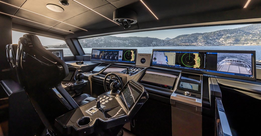 A wide-angle view of the Pershing GTX116 helm station, complete with widescreen navigation systems and carbon fiber pilot seat