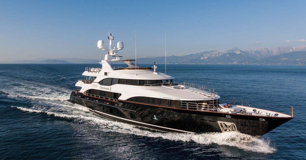 Benetti yacht with dark hull cruising on water