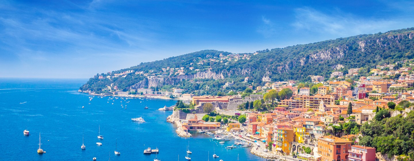 Elevated view of the French Riviera coastline, Mediterranean settlement surrounded by sea and yachts at anchor