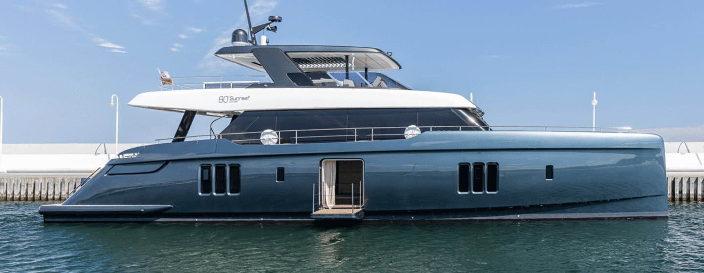 80 Sunreef Power yacht on calm sea with cloudless sky in the background