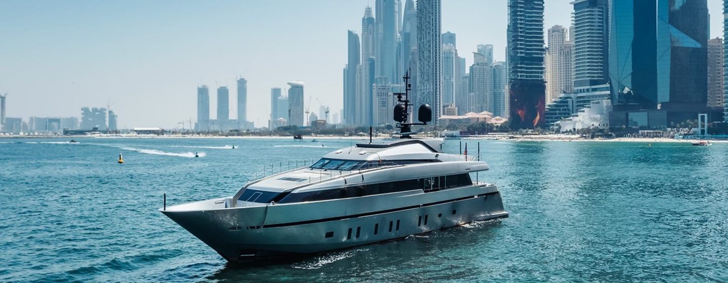 Superyacht Lady A for sale at anchor in front of big city skyscrapers