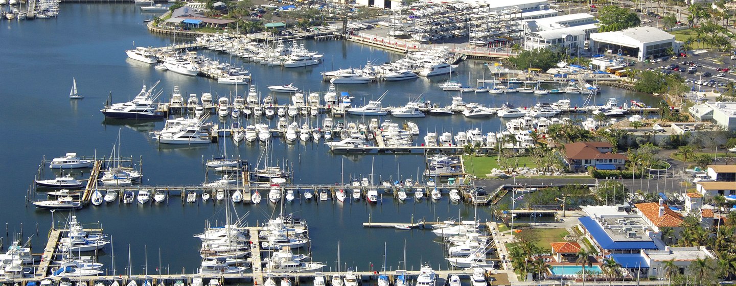 Aerial view of Bayshore Landing, with multiple motor yachts moored and Coconut Grove settlement