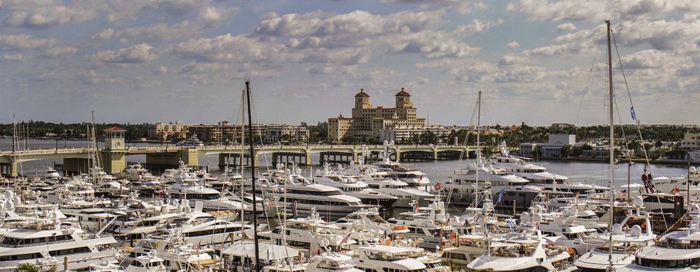 Overview of PBIBS, many motor yachts moored in marina, surrounded by Palm Beach infrastructure