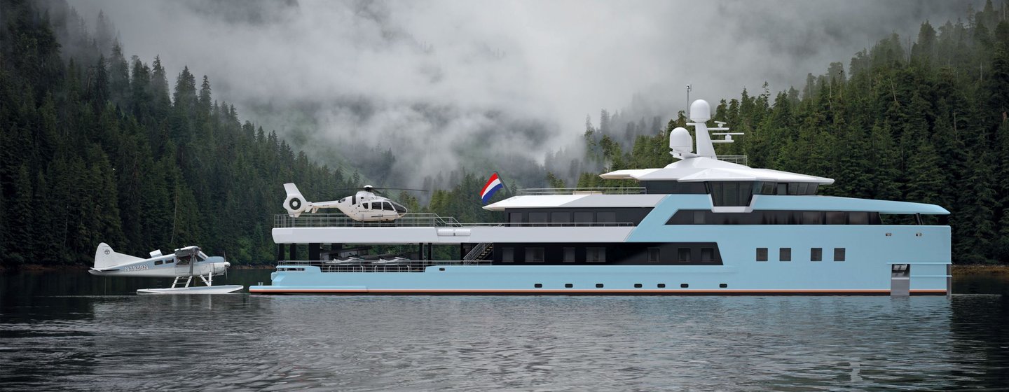 Side view of Damen SeaXplorer 55 expedition yacht with helicopter on the aft deck and seaplane behind, surrounded by dense forest and mountains