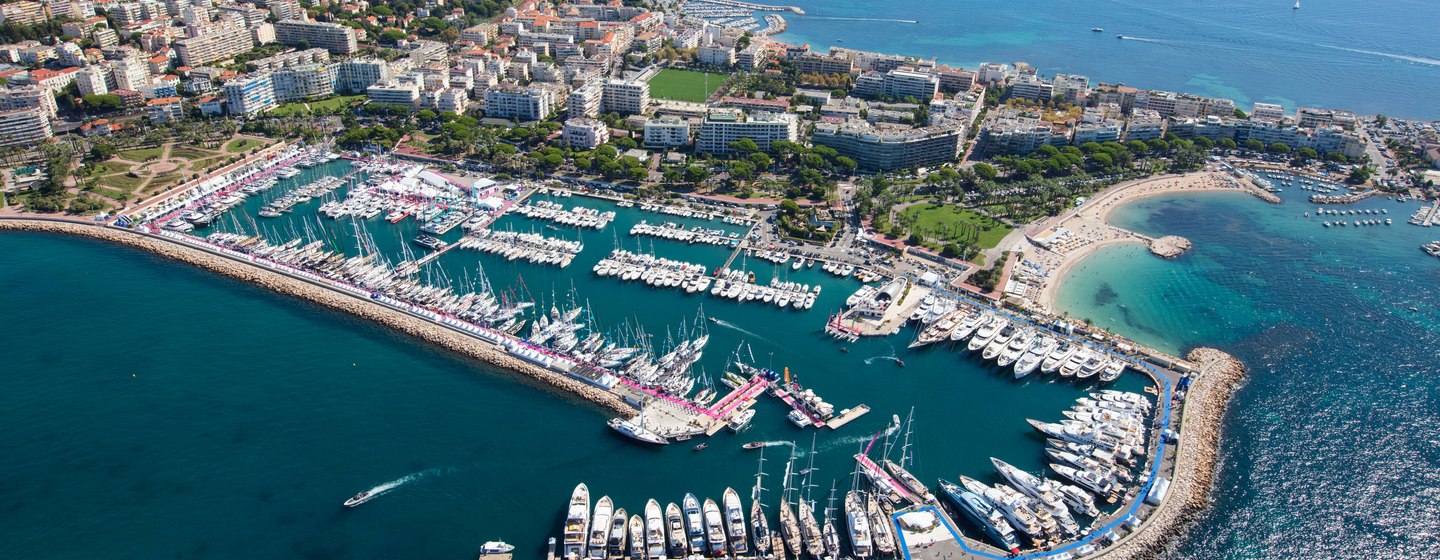 Aerial view of Cannes Yachting Festival, surrounded by Cannes skyline and sea