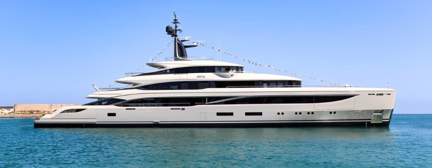 A starboard-side view of IRYNA, Benetti's first B.Now 67, post launch floating in a calm blue sea