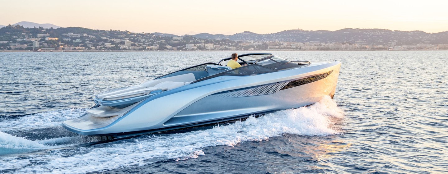 Sideview of Princess R35 underway surrounded by sea and distant coastline