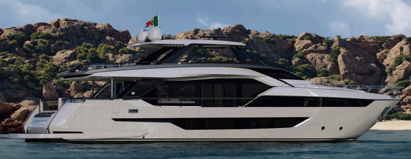 A render of the Ferretti 940 flybridge yacht floating at sea in front of a mountainous backdrop