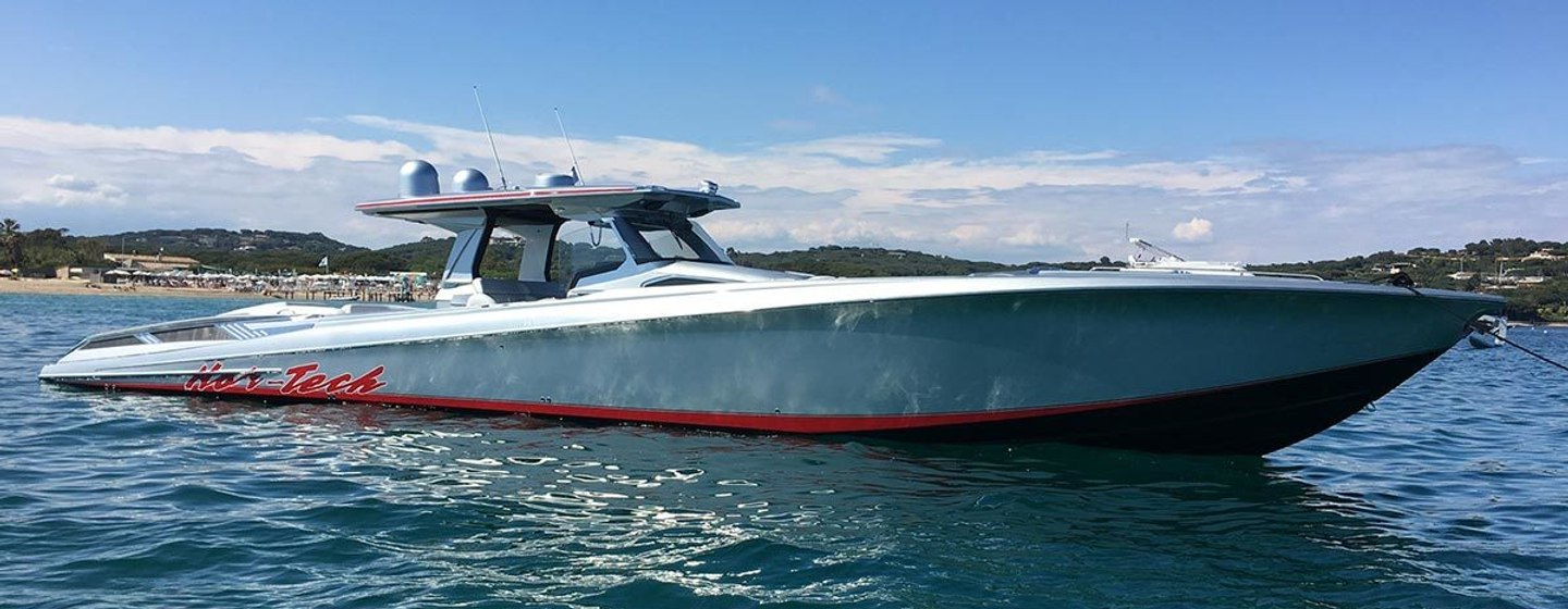 Angular chase boat on water with blue skies in background