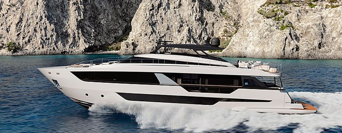 Side view of Ferretti 1000 underway with cliff in background