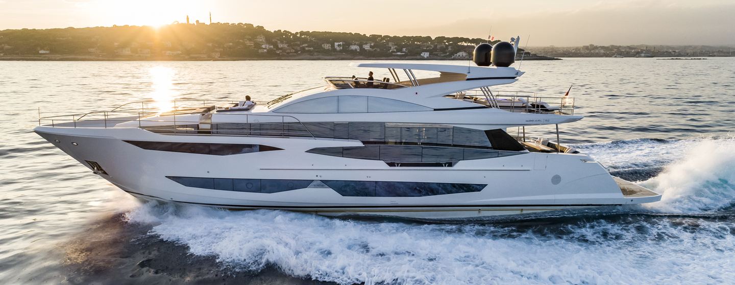 Pearl 95 superyacht being driven on sea with sun setting and spray from yacht