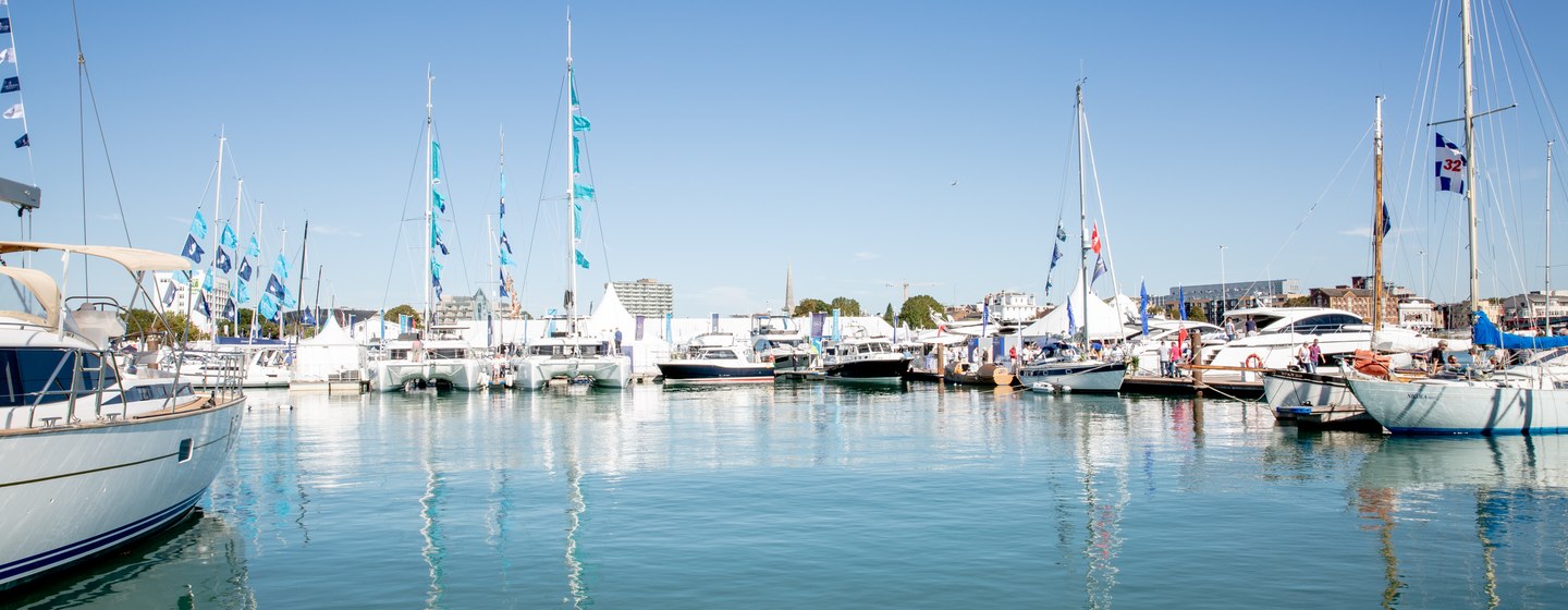 Overview of Southampton marina, with boats lined up at berths and clear blue sky