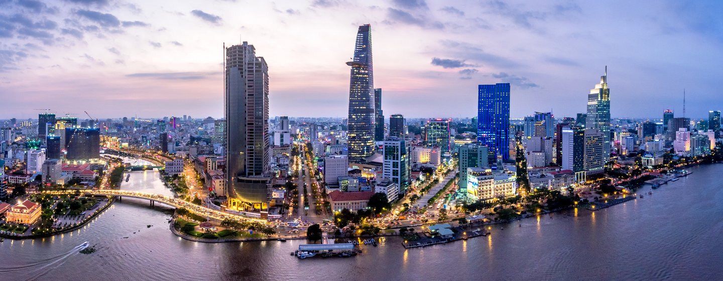 Overview of Ho Chi Minh City skyline at dusk, surrounded by sea and moored yachts