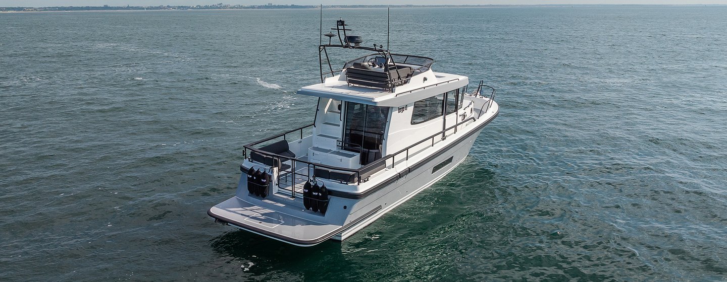 Targa 41 motor boat mid aerial view over starboard quarter deck and along side profile, calm sea, fairly bright day, stationary in water