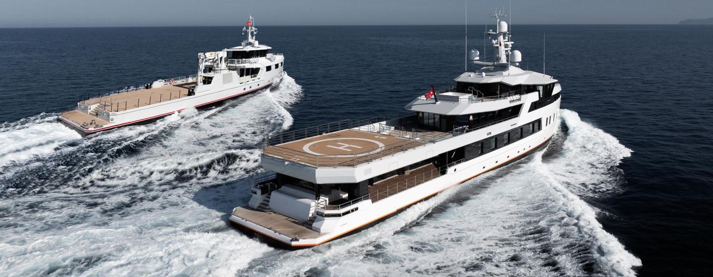 Explorer yacht After You and support vessel Emotional underway stern view 