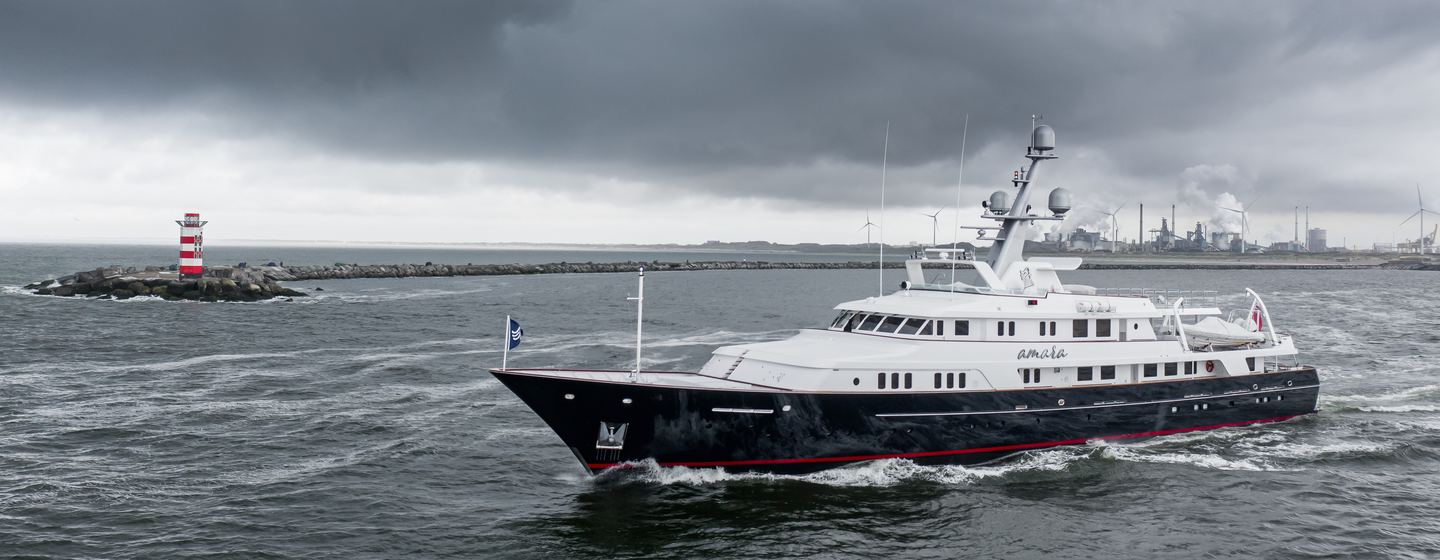 Superyacht AMARA on water under grey skies