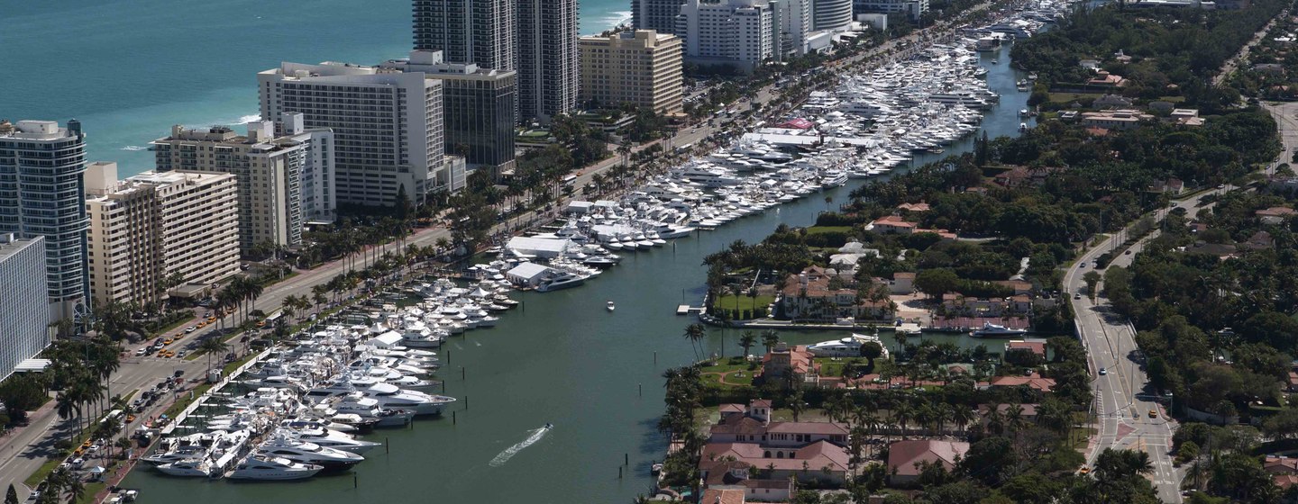 Aerial view of boats lined up in front of large builders