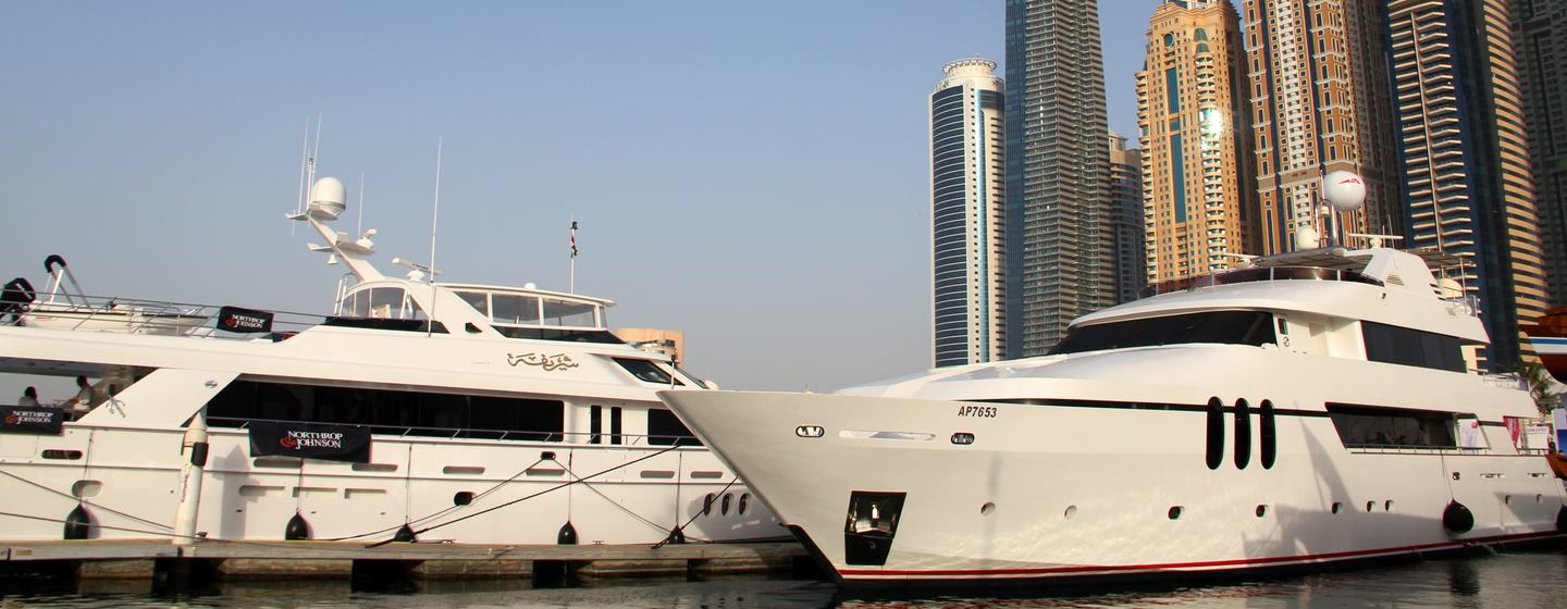 Yachts in front of skyscrapers at Dubai International Boat Show