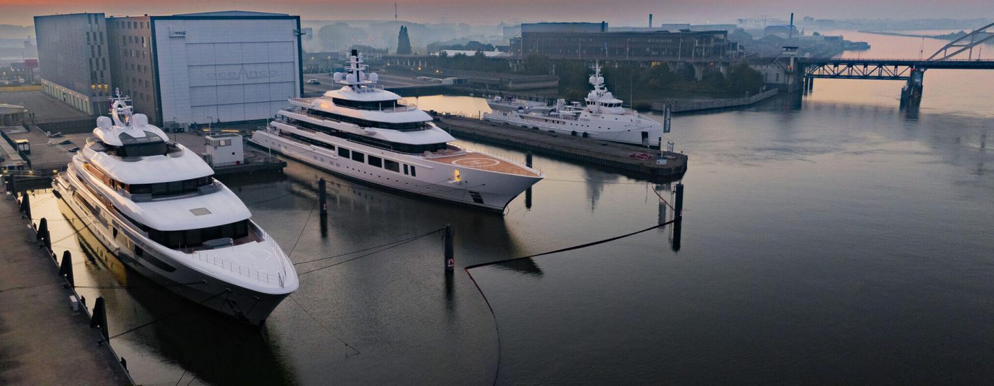 Superyachts outside Oceanco shipyard at dusk