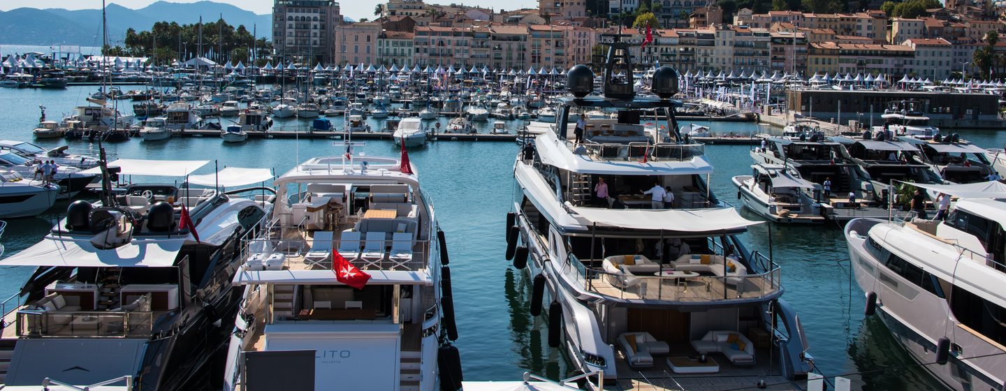 Yachts in harbour at Cannes with historic town in background