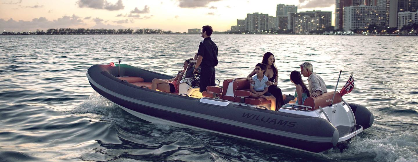 Williams Jet Tender carrying family with cityscape in background