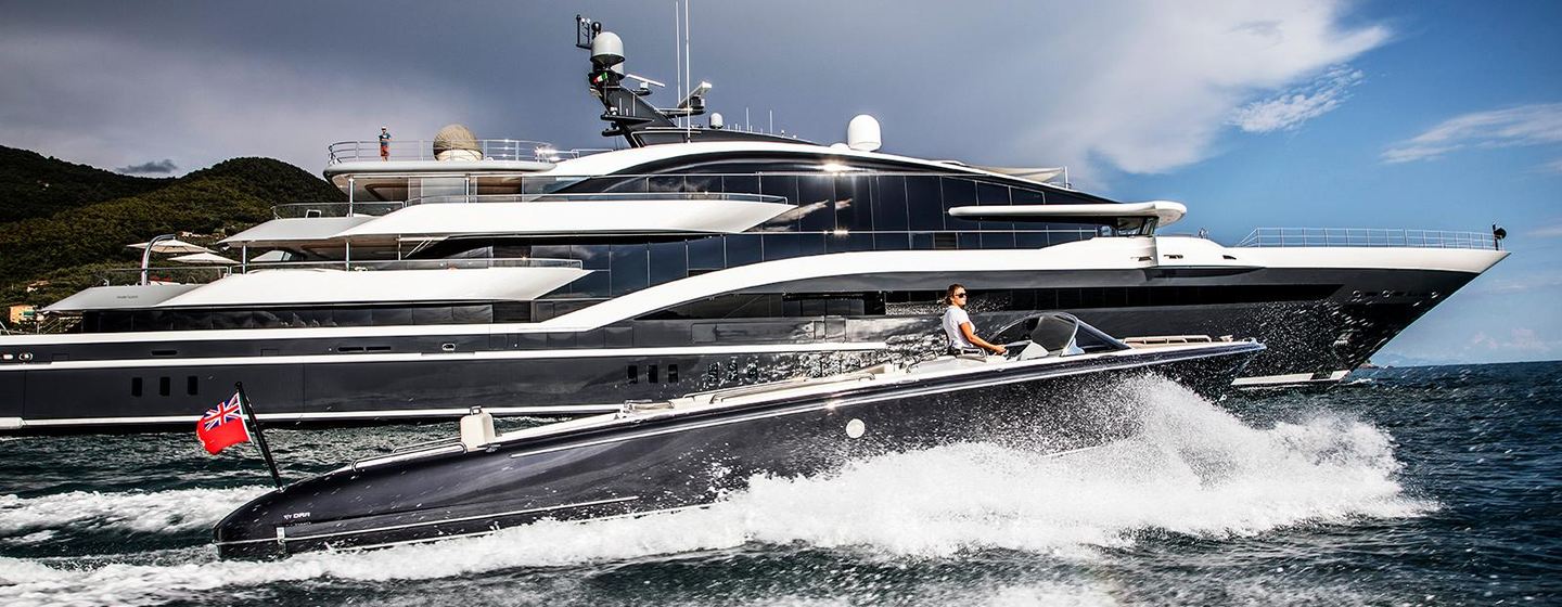 Oceanco yacht DAR in running shot with custom tender in foreground, bright day, both moving fast