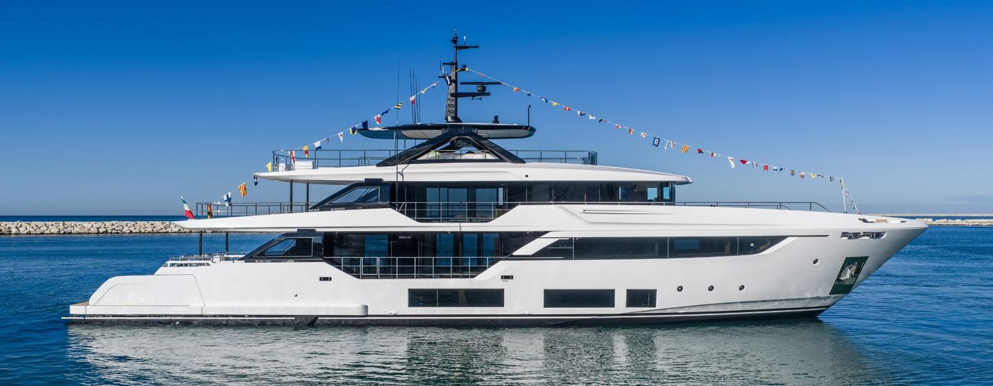Fifth Custom Line Navetta 38 motor yacht with bunting at launch ceremony
