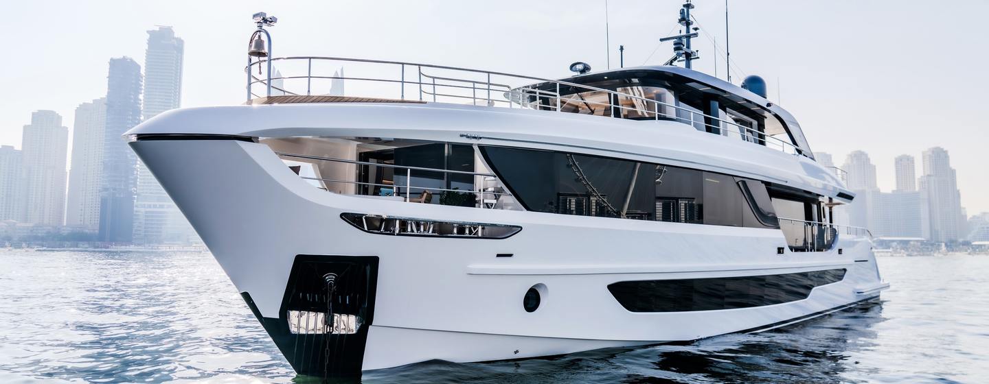 First Majesty 100 Terrace Superyacht at anchor with city skyline behind 