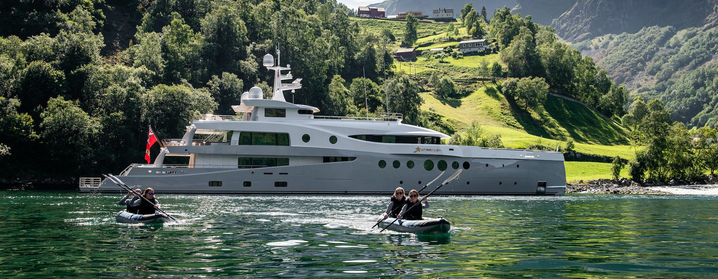 Overview of Amels Limited Editions 206 STARDUST and canoes in scenic mountain location, surrounded by sea