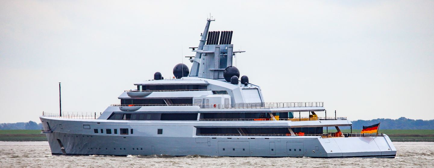 Lurssen yacht Project Ali Baba on sea trials, water level shot towards port side aft deck and along side profile, cloudy day, moderate sea