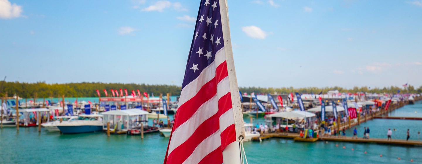 American flag in foreground with boats in background