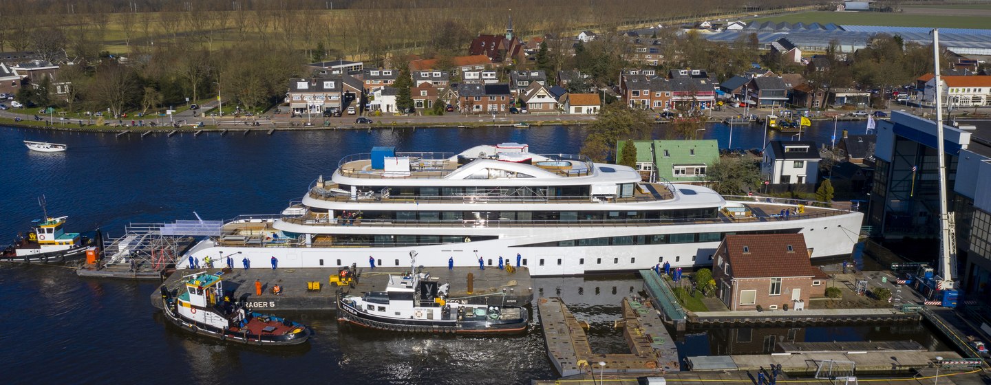 Feadship superyacht VIVA being launch with houses in background