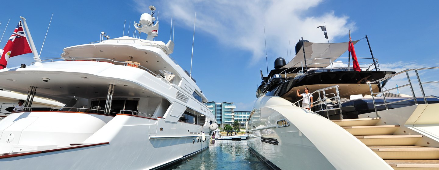 Close up of two superyachts at Singapore Yacht Show