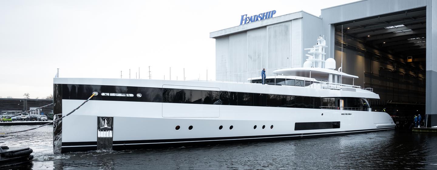 Superyacht Project 717 leaving Feadship shipyard facility during launch
