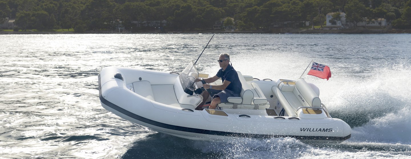 Williams Jet Tender 445 on water with man at helm