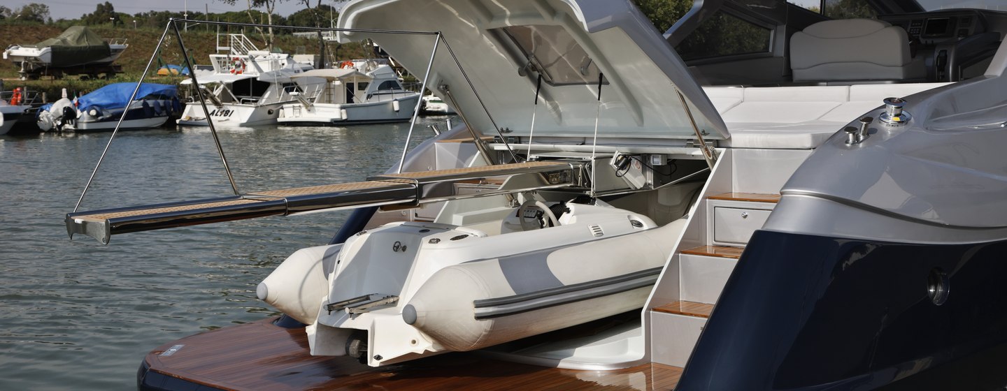 RIB tender emerging from tender garage on back of yacht