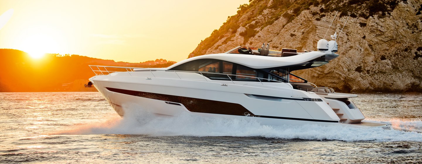 Fairline Phantom 65 on water at sunset