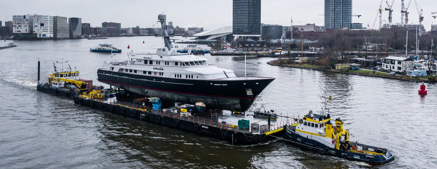 Feadship AMARA being transported on river