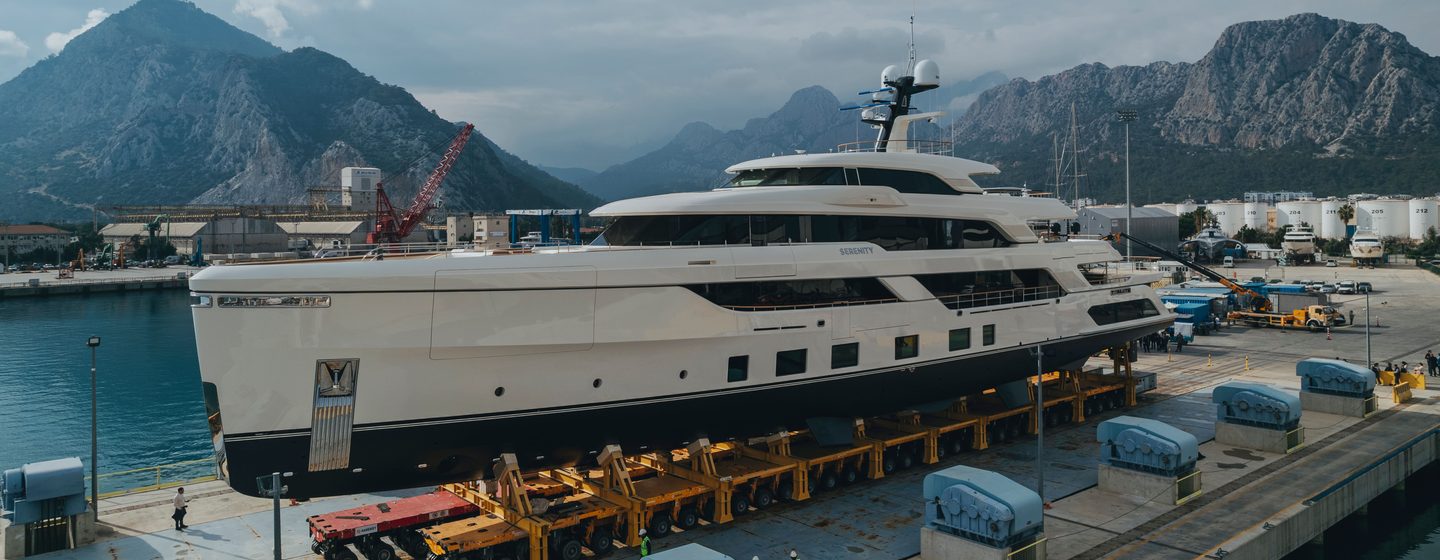 Superyacht Serenity II on trolley on way to launch with mountains in the background