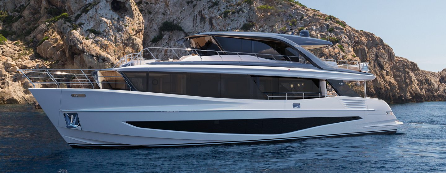 Princess X90 flybridge yacht at anchor side view 
