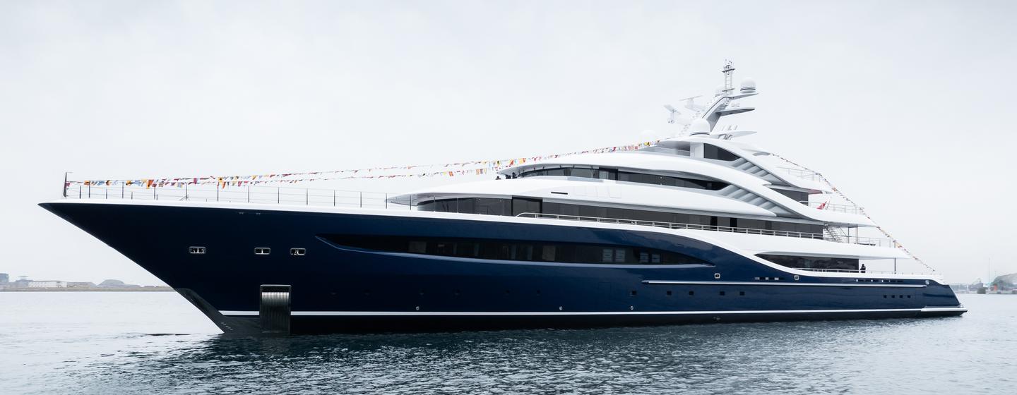 Turquoise superyacht Angelique at anchor side view 