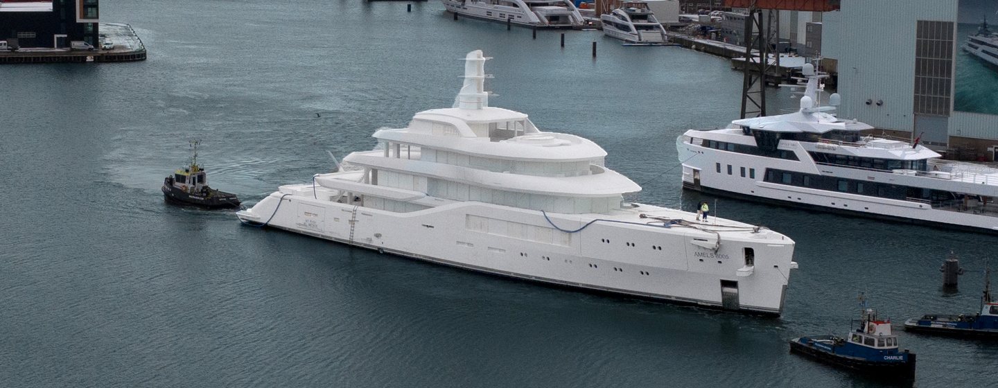 Fifth Amels 80 superyacht behing tugboat arriving at Damen Yachting Vlissingen facilities 