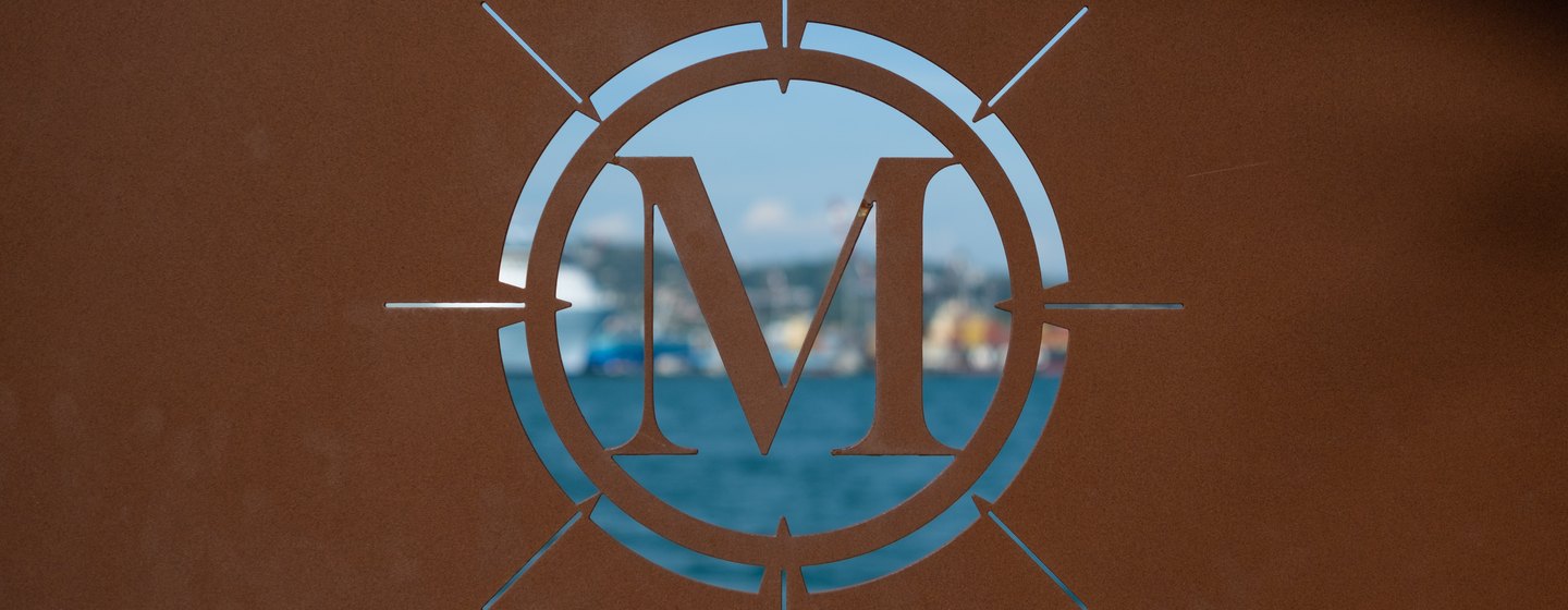 A close-up shot of the Port Mirabello sign