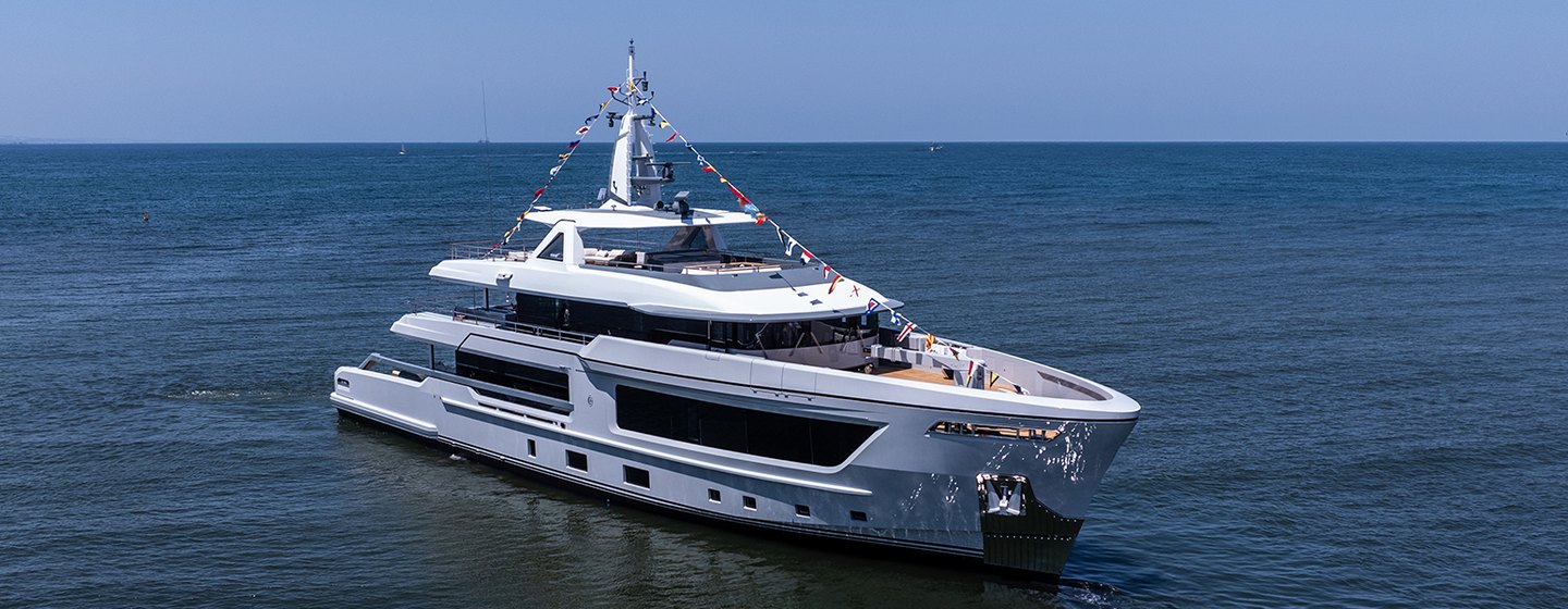 CDM explorer yacht BABBO shown mid aerial shot towards starboard bow and side profile, calm day with bright blue sky and still waters