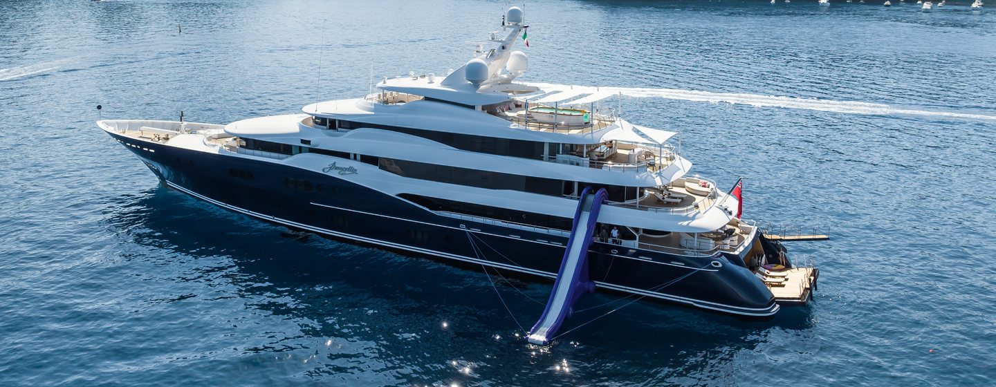 Superyacht Amaryllis at anchor with tenders and inflatable slide