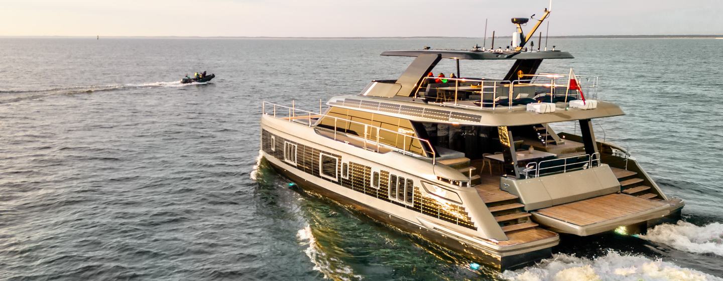 Sunreef 60 Power Eco wins Best Electric Catamaran, image shows the power catamaran making way in smooth sea, from port quarter deck and side profile