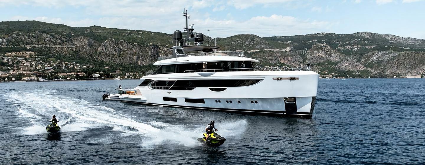 Superyacht Contigo with jet skis in front