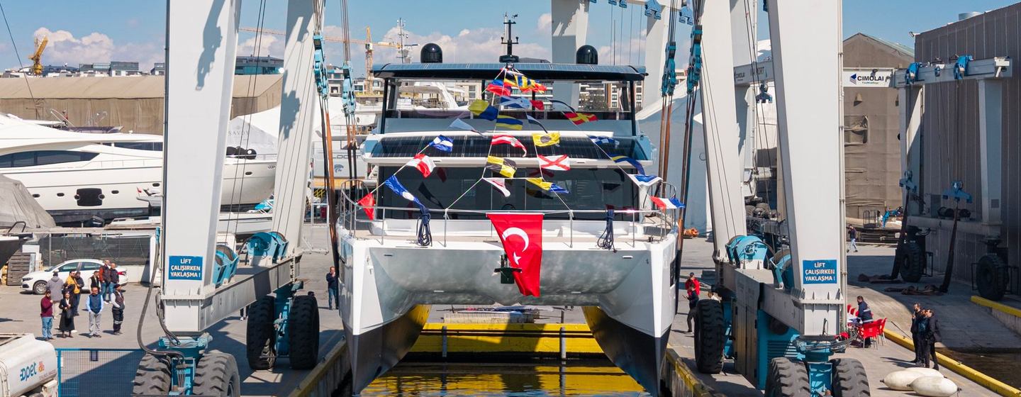 VisionF 65 catamaran being lowered in the water at launch