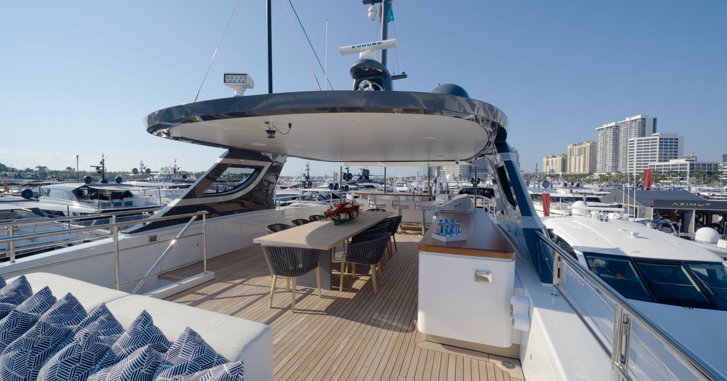 Benetti Oasis 34M sundeck with alfresco dining area, hardtop shade and outdoor bar.